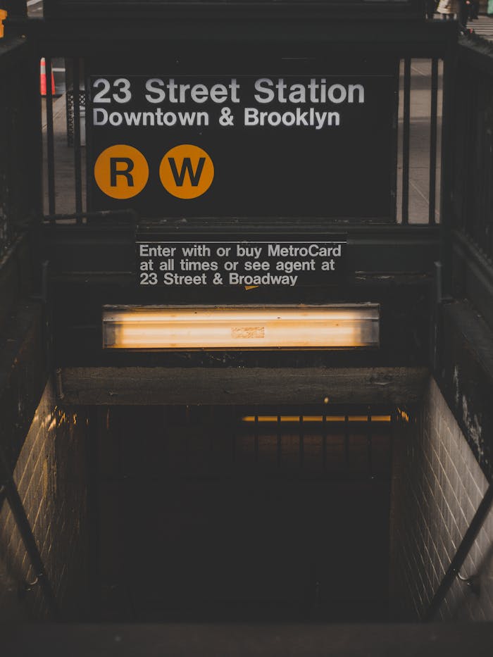 A view of the 23 Street Station subway entrance in New York City, highlighting urban transit.
