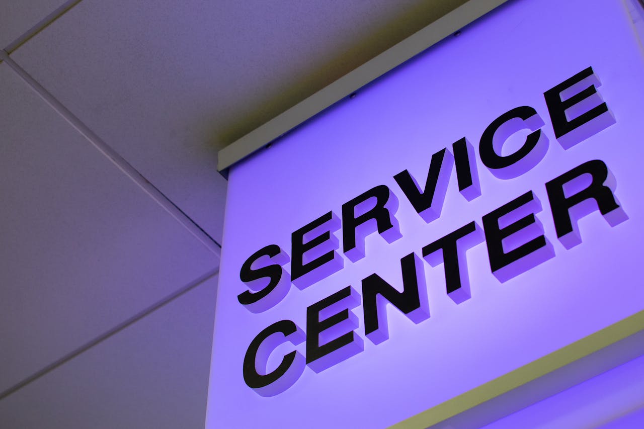services-img Close-up of a modern illuminated Service Center sign in a building interior.