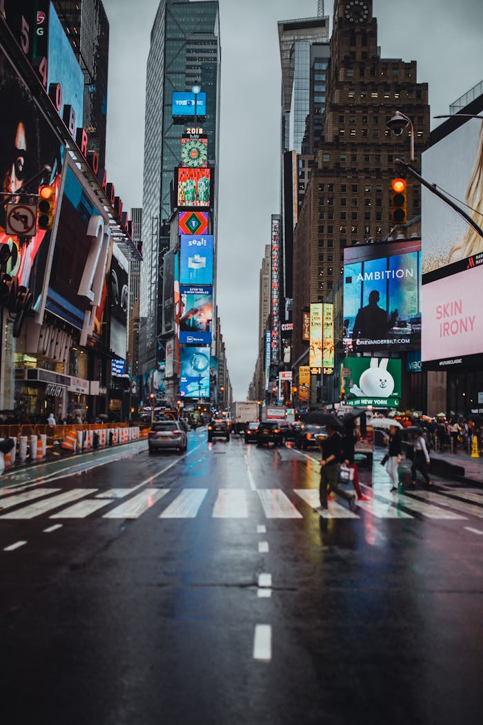 services-03 Bustling Times Square in New York City with illuminated billboards and pedestrians crossing.